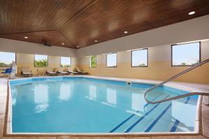a large pool with blue water in a building at Country Inn & Suites by Radisson, DFW Airport South, TX in Irving