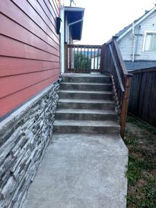 uma escada que leva a uma casa com uma parede vermelha em Hidden Gem in Downtown Tacoma em Tacoma