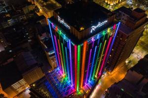 een gebouw met 's nachts kleurrijke verlichting bij Radisson Montevideo Victoria Plaza Hotel in Montevideo
