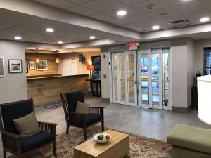a lobby of a hospital with chairs and a table at Country Inn & Suites by Radisson, Emporia, VA in Emporia