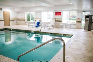 a pool in a hospital with chairs and tables at Country Inn & Suites by Radisson, Richmond West at I-64, VA in Richmond
