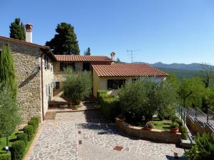 a stone house with a garden in front of it at Attractive Holiday Home in Montecarelli with Pool in Montecarelli