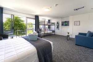 a bedroom with a bed and a living room at Urban Lounge Sleepery, SureStay Collection by BW in Rotorua