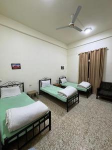 1 Schlafzimmer mit 2 Betten und einem Deckenventilator in der Unterkunft Roman Theater Hotel in Amman