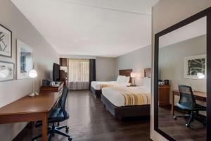 a hotel room with two beds and a desk at Country Inn & Suites by Radisson, Fredericksburg South I-95 , VA in Fredericksburg +37 photos