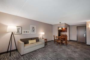 a living room with a couch and a table at Country Inn & Suites by Radisson, Fredericksburg South I-95 , VA in Fredericksburg