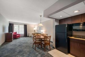 a kitchen and dining room with a table and chairs at Country Inn & Suites by Radisson, Fredericksburg South I-95 , VA in Fredericksburg