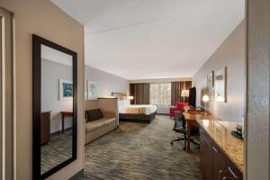 a hotel room with a bed and a desk at Country Inn & Suites by Radisson, Fredericksburg South I-95 , VA in Fredericksburg