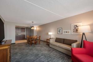 a living room with a couch and a table at Country Inn & Suites by Radisson, Fredericksburg South I-95 , VA in Fredericksburg