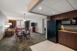 a kitchen and dining room with a table and chairs at Country Inn & Suites by Radisson, Fredericksburg South I-95 , VA in Fredericksburg