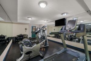 a gym with cardio machines and a tv in it at Country Inn & Suites by Radisson, Fredericksburg South I-95 , VA in Fredericksburg
