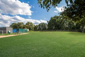a park with a bench on a grass field at Country Inn & Suites by Radisson, Fredericksburg South I-95 , VA in Fredericksburg