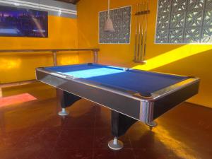 a pool table in the middle of a room at Buena Onda Backpackers in San Juan del Sur