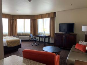 a hotel room with a bed and a flat screen tv at Radisson Hotel River Falls in River Falls