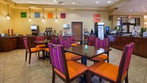 a restaurant with tables and chairs and a bar at Radisson Hotel River Falls in River Falls