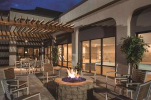 a patio with chairs and a fire pit in front of a building at Country Inn & Suites by Radisson, La Crosse, WI in La Crosse