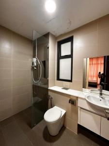 a bathroom with a toilet and a sink and a shower at Setia Sky88 Johor Bahru in Johor Bahru