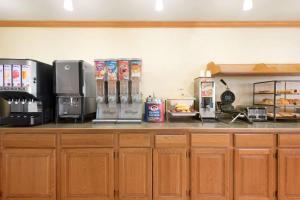 a kitchen with a counter top with coffee machines at Country Inn & Suites by Radisson, Milwaukee Airport, WI in Milwaukee