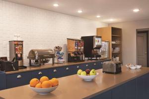 a kitchen with bowls of fruit on a counter at Country Inn & Suites by Radisson, Madison, WI in Madison