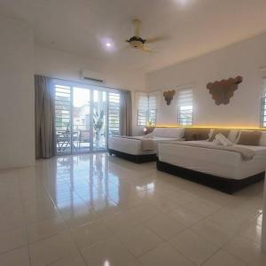 a large living room with two couches and a large window at Taiping Holiday Home in Taiping