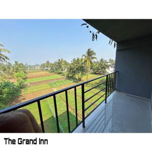 a balcony with a view of a field at The Grand Inn in Nirmal