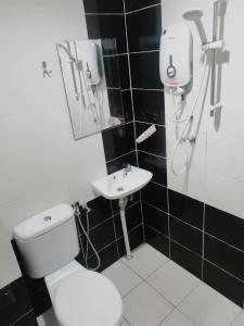 a bathroom with a toilet and a sink at Mikayla hotel in Port Dickson