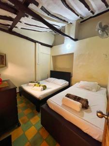 - une chambre avec 2 lits dans l'établissement Hotel Solárium Posada, à Socorro