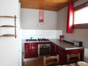 a kitchen with a stove and a sink in it at Appartement Chamrousse, 2 pièces, 6 personnes - FR-1-340-278 in Chamrousse