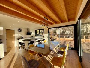 a kitchen and dining room with a table and chairs at Chalet 5 pièces, garage, terrasse, 8 pers - FR-1-608-263 in Le Mont-Dore