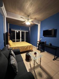 a living room with a bed and a ceiling fan at Brisa del Mar #2 in Brisas de Zicatela