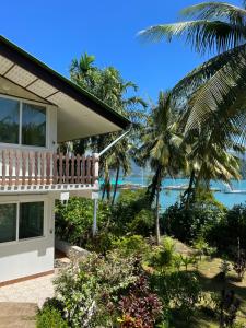 a house with a balcony and a view of the ocean at Island View Resort Koh Chang in Ko Chang