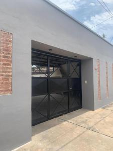 a garage with a large glass door on a building at Monoambiente in Corrientes