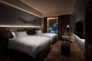 Postel nebo postele na pokoji v ubytování Nest Hotel Osaka Umeda