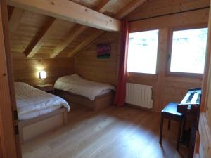 a small room with two beds in a cabin at Chalet Le Grand-Bornand, 7 pièces, 10 personnes - FR-1-458-193 in Le Grand-Bornand