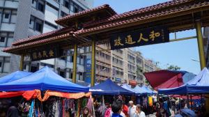 a market with blue umbrellas in front of a building at Stanton Gaya Hotel in Kota Kinabalu