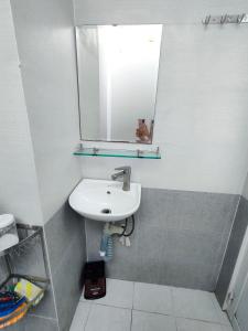 a bathroom with a sink and a mirror at NATURAL HOUSE hostel in Ho Chi Minh City