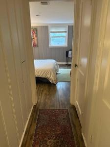 a hallway with a bedroom with a bed and a rug at Roomy Oasis DC area pet friendly in Takoma Park