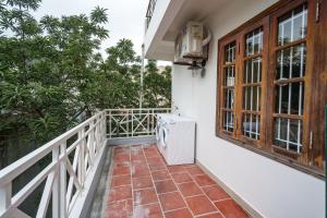a balcony of a house with a washing machine at House of Comfort - 3 BR & 3 baths - 1' to Hoan Kiem Lake & Old Quarter in Hanoi