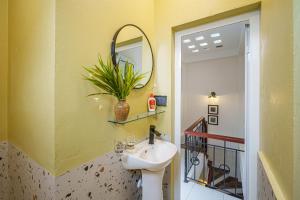 a bathroom with a sink and a mirror at House of Comfort - 3 BR & 3 baths - 1' to Hoan Kiem Lake & Old Quarter in Hanoi +26 photos