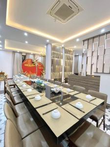 a large dining room with a long table and chairs at QUEEN VILLA in Ha Long