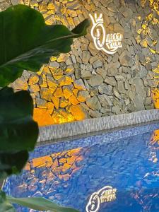 a painting of a pool with rocks and water at QUEEN VILLA in Ha Long