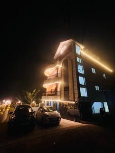 a building with cars parked in front of it at night at Forest View Resort in Yercaud