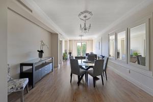 a living room with a dining room table and chairs at Unit 305 Cape Royale Luxury Apartments in Cape Town