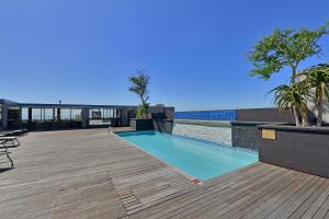 a swimming pool on the roof of a building at Unit 305 Cape Royale Luxury Apartments in Cape Town