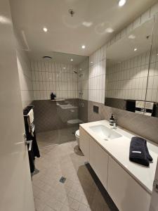 a bathroom with a sink and a toilet and a mirror at Metro Retreat on Burnley in Melbourne