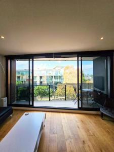 a living room with a large window with a view at Metro Retreat on Burnley in Melbourne