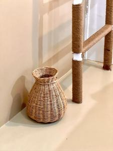 a wicker basket sitting on a shelf next to a window at The Canopy Krabi in Ao Nang Beach