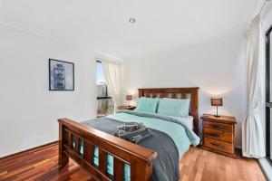 a bedroom with a large bed with blue pillows at Spacious & Serene! 3Bed/2Bath/2+Cars ~ House in Mount Ommaney