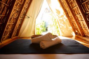 a pair of towels sitting on a black yoga mat at Porã Chacahua in Guayabas