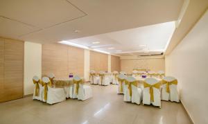 a row of tables and chairs in a banquet hall at Treebo Trend Cabana in New Delhi